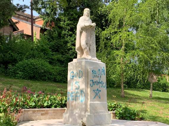 Graffiti of a religious nature on the statue to St Boniface in Newcombes Meadow in 2020. AQ 9613