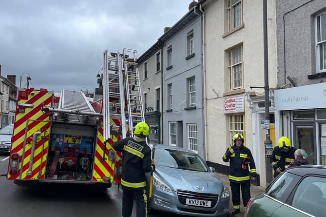 Firefighters at the scene of the fire in Crediton High Street.