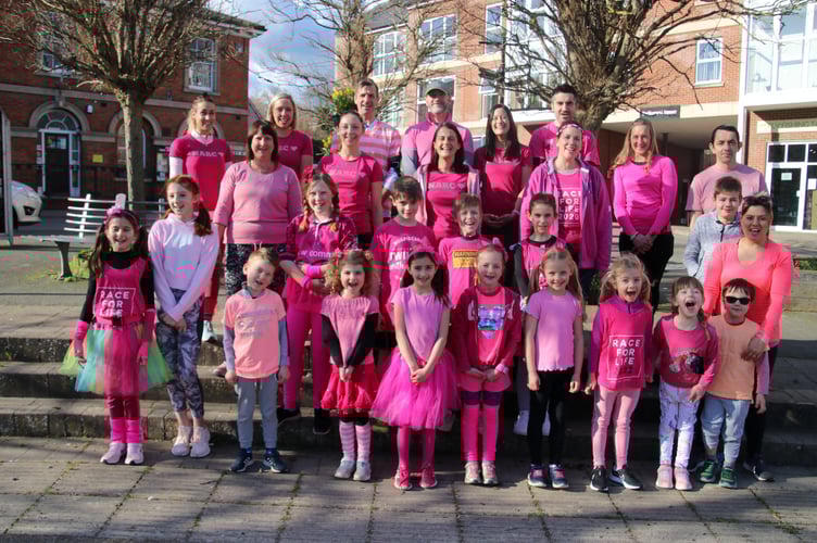 The children, parents and organisers of the Crediton Junior Race for Life before the event began, pictured in Crediton’s Town Square.  AQ 5001
