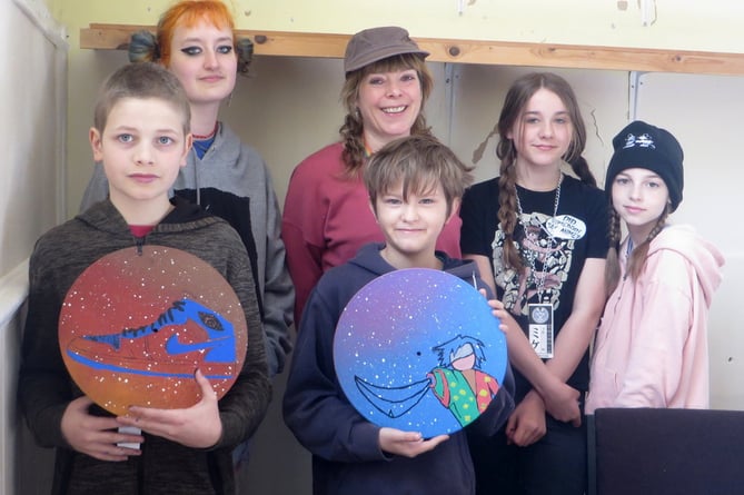 Youth workers Catherine Kelly (right) and August Shaw with four of the young people, two holding vinyls they had painted.  SR 1392
