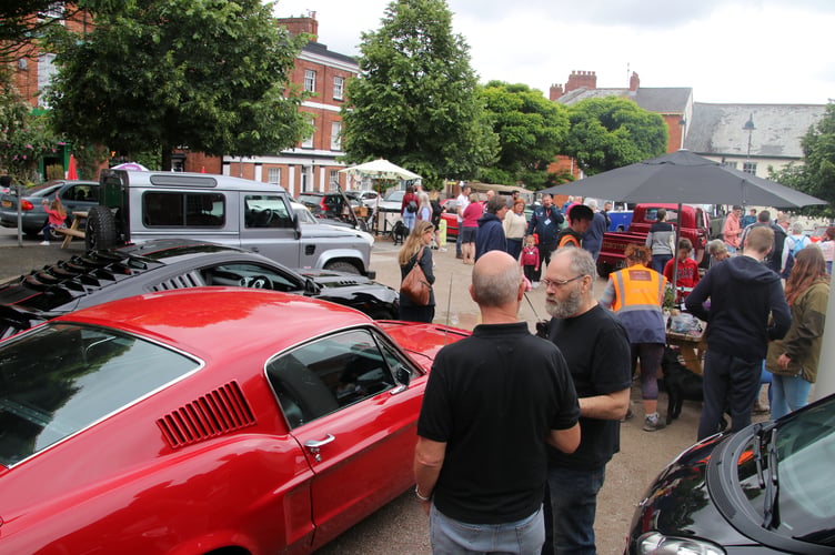 A good crowd on the town square at one of last year’s Cars and Coffee events. AQ 2198