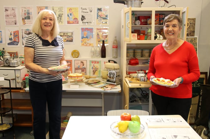 Crediton Museum 1950’s Exhibition curators Cheryl Lewis and Mavis Monaghan in the kitchen area.  AQ 5973
