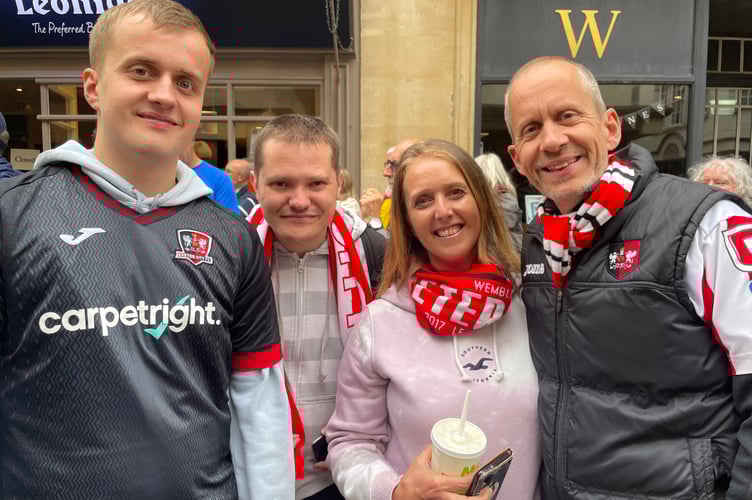 Crediton area supporters lining Exeter High Street to welcome the Grecians.
