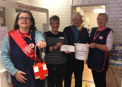 Dave with shop manager Wendy Archer (third left) and Sandra Martin (left) and Wendy Searle (right).  
