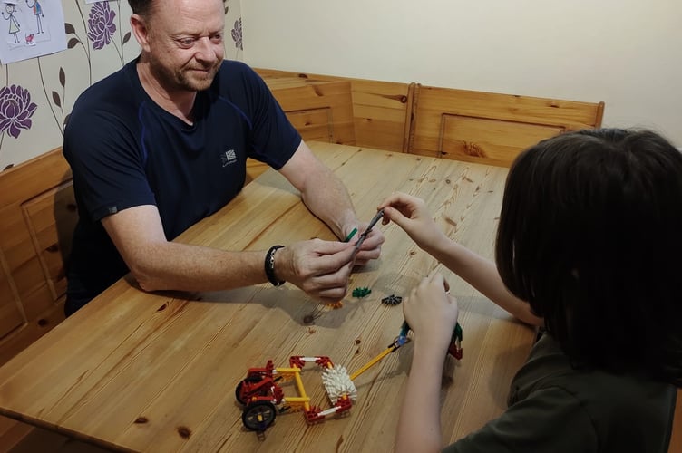 Stuart Penny with a young foster child.