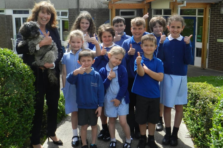 Headteacher Debbie Main with school mascot Coco and one child from each class at Landscore Primary School celebrating the school’s recent Ofsted results.  NP 130522 03

