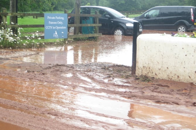 The road through Yeoford is covered in mud and water and the car park of The Duck is currently flooded.  SR 2208
