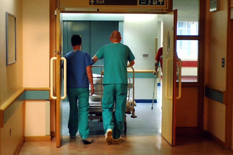 Orderlies push a bed at the Royal Orthopaedic Hospital, Oswestry.