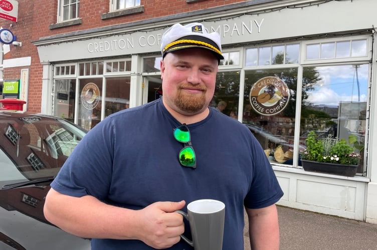 Dan Webb who has left Crediton Coffee Company wearing the Captain’s hat he was presented with by Mr and Mrs Findell as a farewell gift.  AQ 8343
