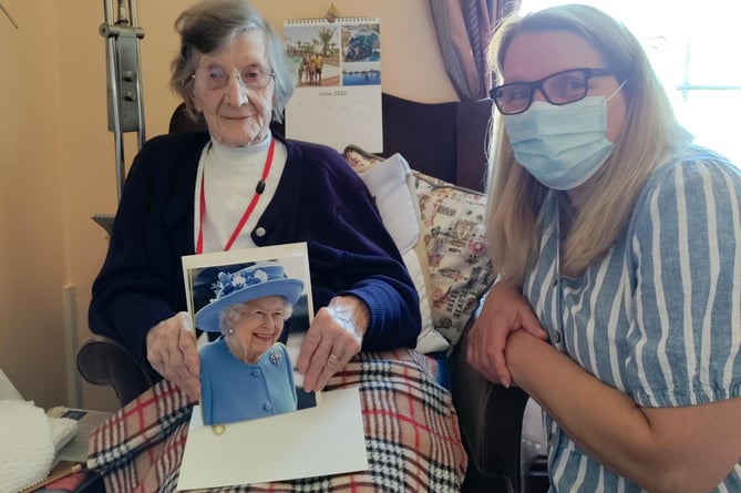 Anne Eddleston holding her card from the Queen, pictured with Sylvia Sandercock, Care Manager, Hillbrow Residential Care Home.
