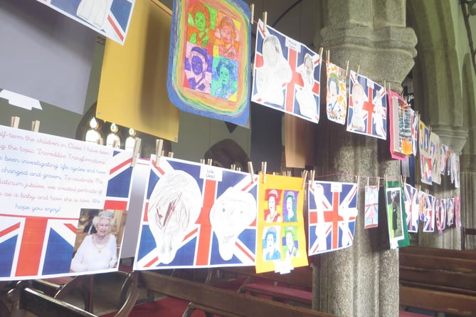 A double row of portraits of the Queen created by pupils of Cheriton Bishop Primary School hung right down through the parish church and back again.  SR 2290
