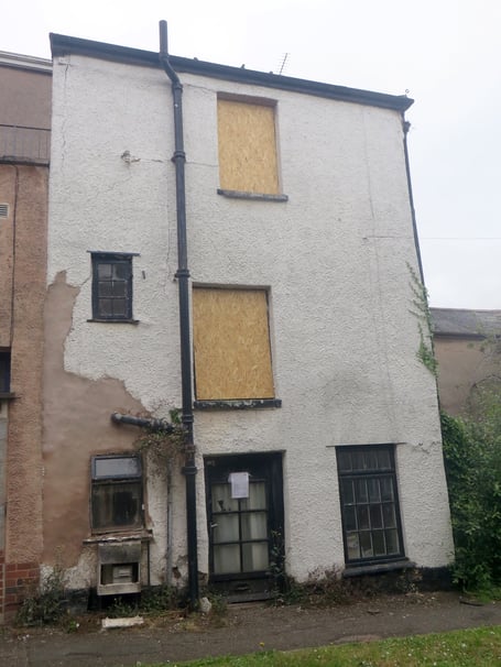 The Cott as it is now with boarded windows, the district council notice on the front door. SR 2714