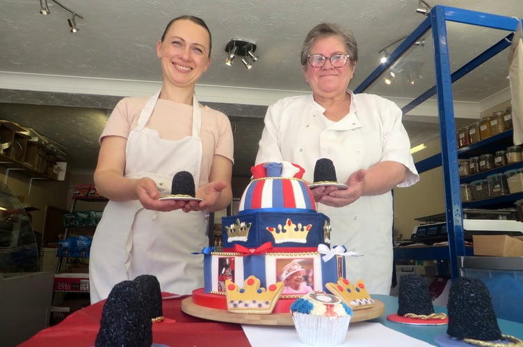 Each holding a little cake busby are Olesia (left) and Lynda at Stevie B’s with the Jubilee cake.  SR 2411
