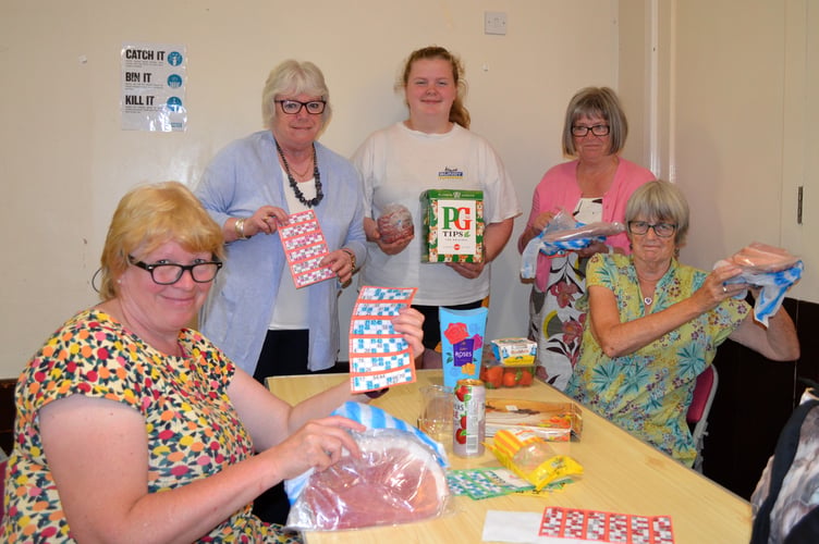 Some happy players at the July Sandford Bingo with their prizes.