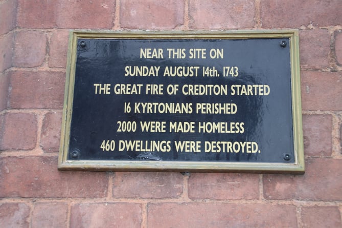 The memorial sign about the Great Fire of Crediton in Crediton High Street. AQ 5216