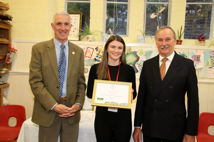 South West in Bloom judge Tony Moore, left, presenting the Pennant Silver Gilt Award to Assistant Crediton Town Clerk Emma Anderson and Britain in Bloom co-ordinator for Crediton, Mike Szabo. AQ 9206