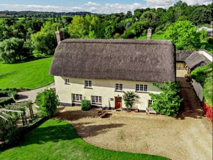 Farmhouse for sale sits on riverbank and has its own summer house 