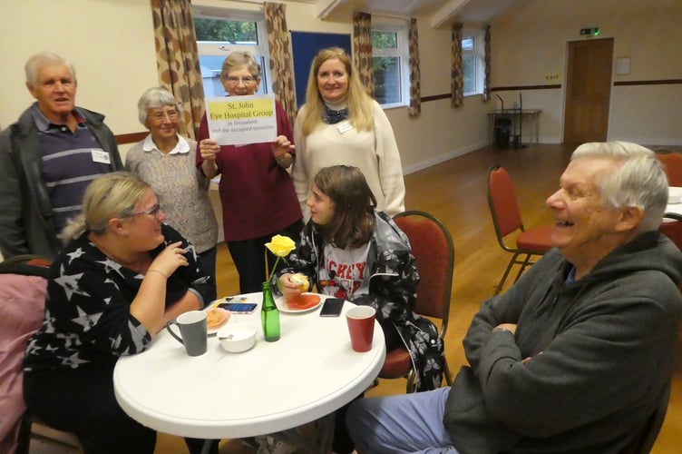A group of helpers at the Afternoon Tea, with visitors, Claire and Lily Cavill and John Knowlton.
