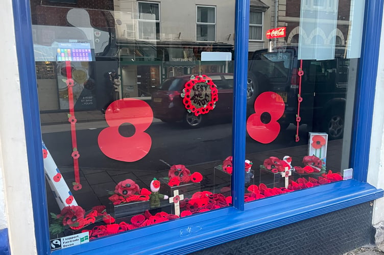 Knitted items form part of the remembrance display in Evans Newsagents window. AQ 8186