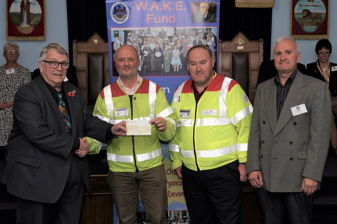 Provincial Grand Master of Devonshire, Ian Kingsbury JP, left, presenting the cheque to SW Blood Bikes representatives.
