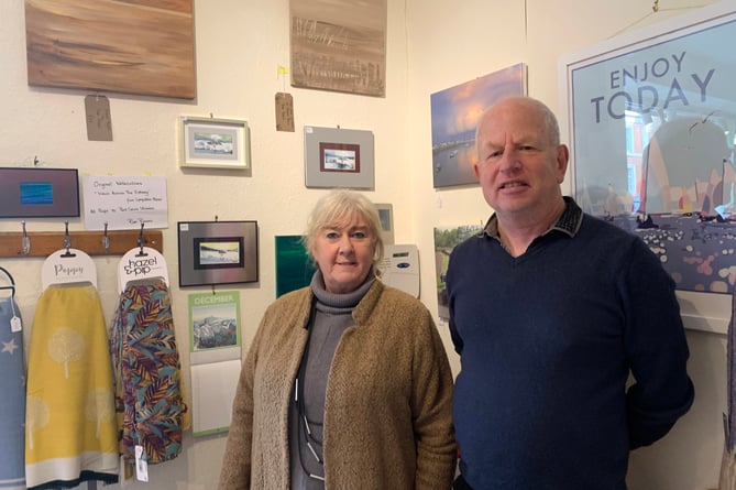 John Crocker of Mimosa and artist Ruth Rozario in front of the paintings offered for sale in aid of Rotary shelter boxes.

