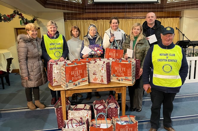 Members of the Rotary Club of Crediton Boniface with some of the Ukrainian families who received bags of Christmas food.
