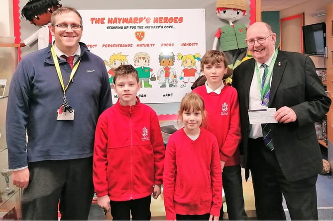 Three of the Ukrainian children who go to Hayward's School together with the Head Teacher, Andy Smith, receiving the cheque from Peter Brewer, Secretary of the Lodge.
