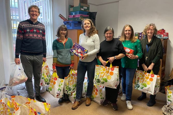 Volunteers and trustees with some of the Christmas Hamper bags which were distributed on December 23.  AQ 0937
