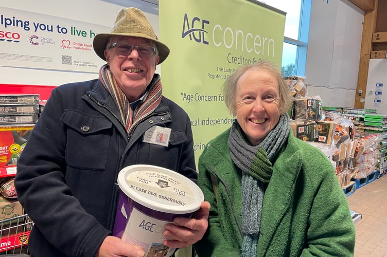 Philip Hutchens, volunteer collector, pictured with a shopper making a donation at Crediton’s Tesco store.  AQ 0542
