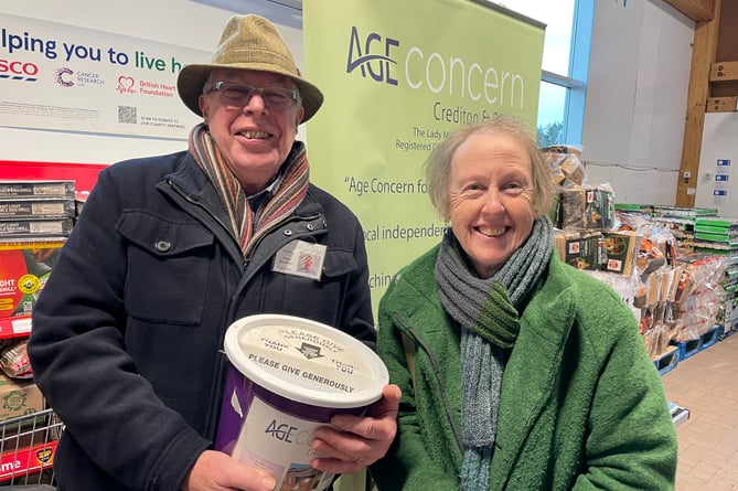 Philip Hutchens, volunteer collector, pictured with a shopper making a donation at Crediton’s Tesco store.  AQ 0542
