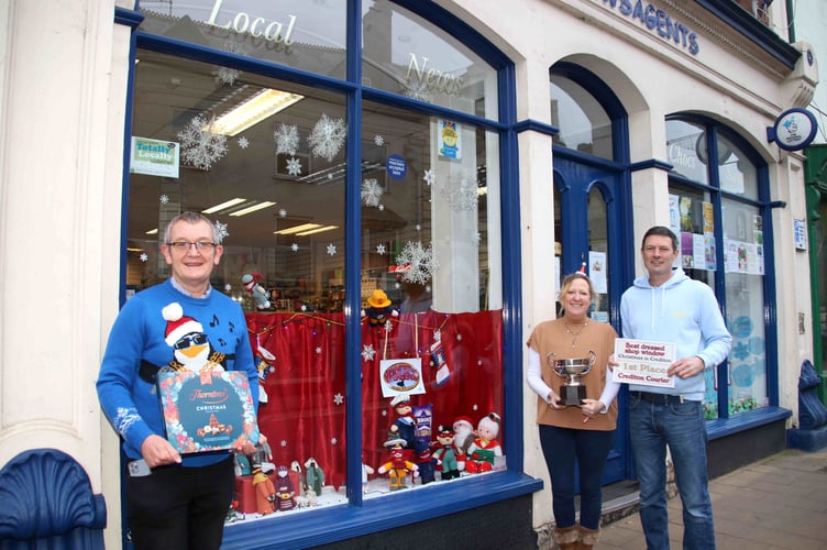 The Best Dressed Shop Window in Crediton in the 2021 competition run by the ‘Crediton Courier’ was Evans Newsagents. The Crediton Rose Bowl was presented by Alan Quick, Editorial Manager, ‘Crediton Courier’, left, and was received by Tara and Paul Conabeare, proprietors. AQ 4783