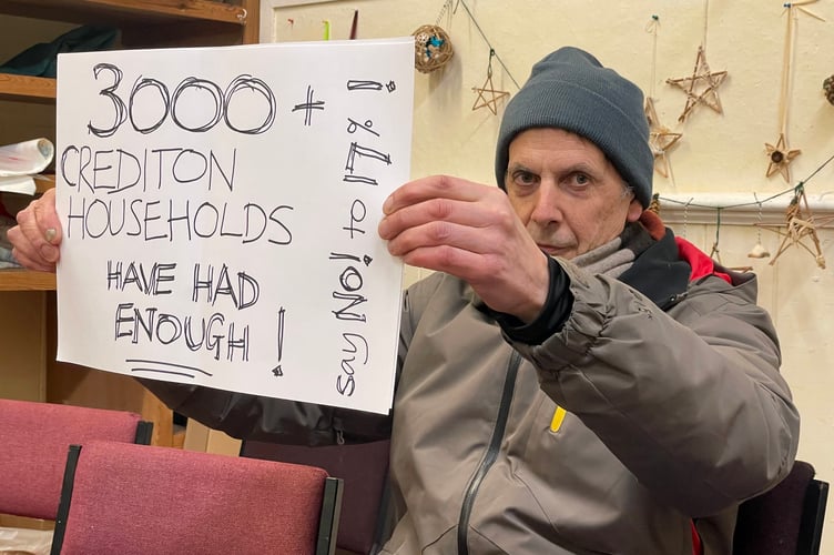 Paul Vincent of Independents for Crediton with one of his placards, pictured at the council meeting. AQ 2277