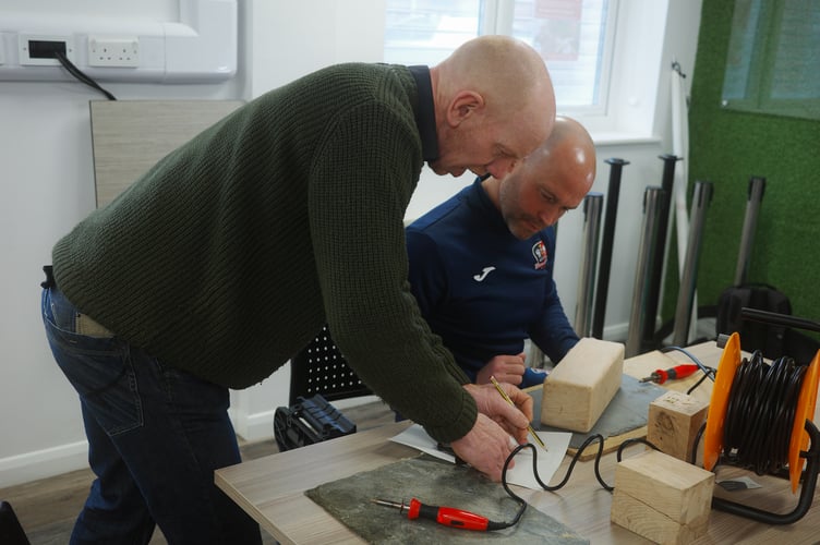 Joe Hancock and Kevin Nicholson during a pyrography session.
