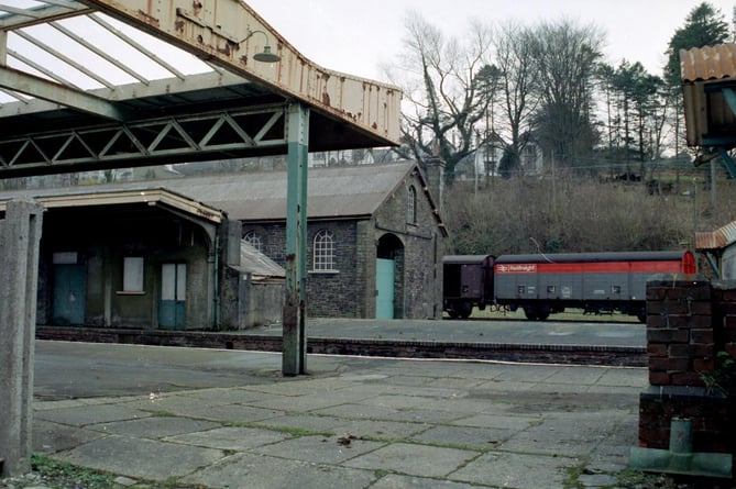 A freight train sits at sidings behind the disused Goods shed at Okehampton in 1982
