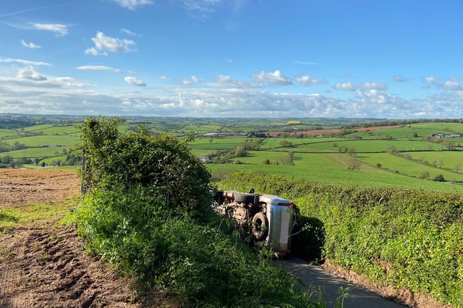 The car on its side in the country lane near Crediton earlier this evening.