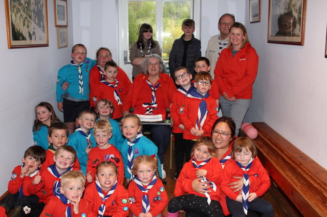 Squirrels Leader Rowena Ford (seated centre) holding their cake with Squirrels, Leaders and (at right back) Group Scout Leader and Cub Leader Phil Roberts.  SR 7485