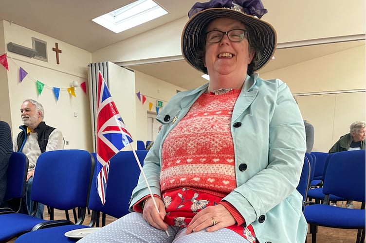 One of the members of the public who watched the ceremony in the Boniface Centre, complete with a flag and Union flag decorated boots. AQ 7608