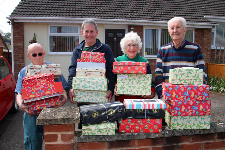From left, Dave Adams, Biffo Holland, Margaret Tucker and Derek Shapland with some of the 70 shoeboxes which left Crediton last week. AQ 0623