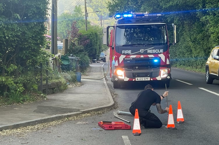 A firefighter opening a hydrant to assist with the fire.