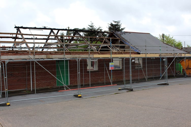 Work has begun on stripping the badly burned roof of the hall.  SR 7715