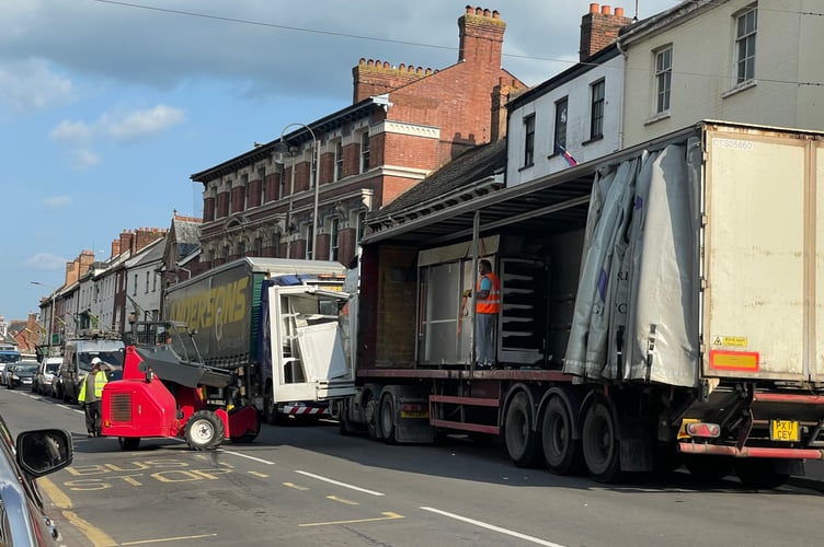 Refrigerator units being loaded onto a lorry.  AQ 9615