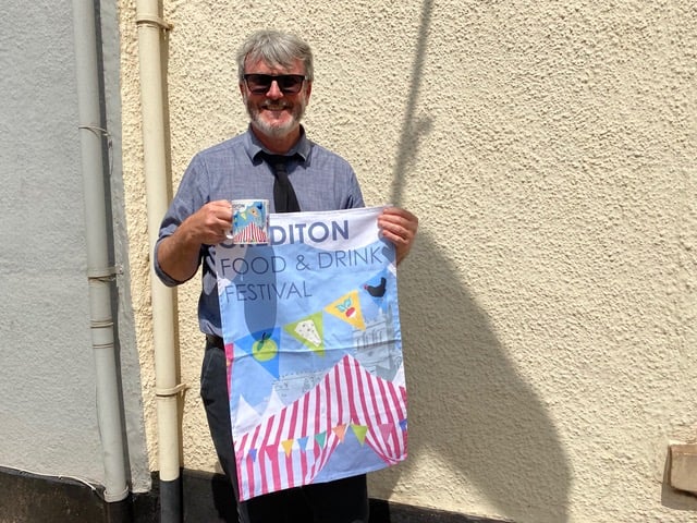 Steve Nicholls, one of the organisers, with examples of a Crediton Food and Drink Festival mug and tea towel which will be available to buy at the Festival.