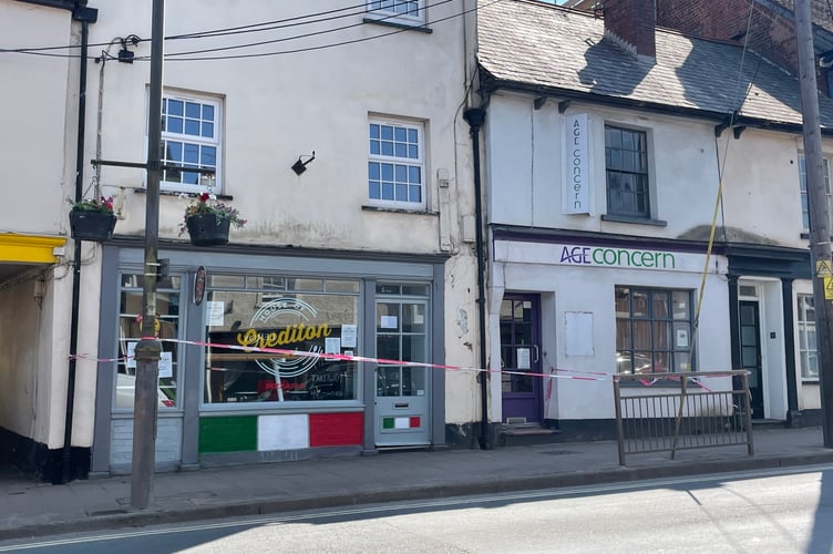 The taped off area of pavement in Crediton High Street. AQ 0369