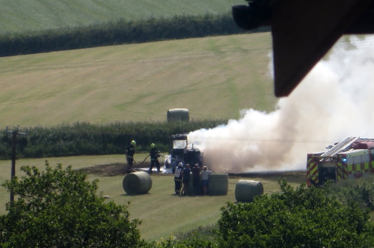 Firefighters tackling the telehandler fire. SR 3191