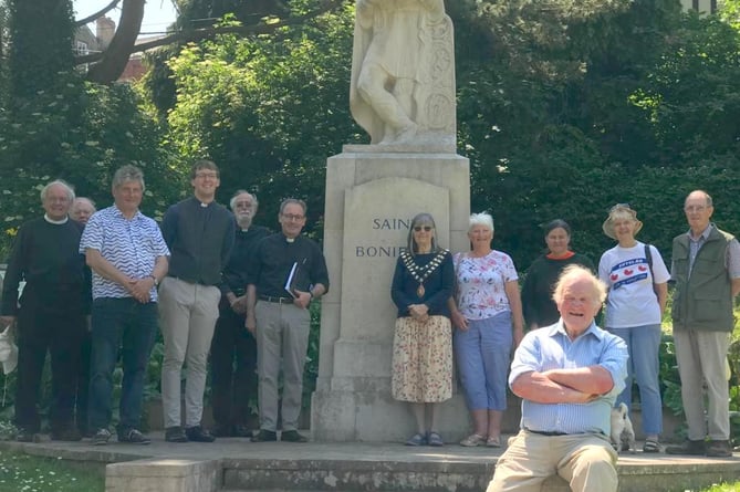 Most of those who gathered for readings and prayers for St Boniface Day at the Saint’s statue in Newcombes Meadow.