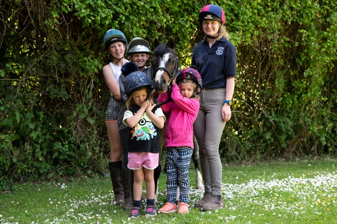 Cracker with vet Alice (right) and his young riders.