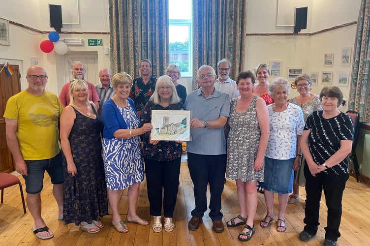 Margaret Burrows, centre left, presents a painting to John and Jo Dike for their contribution to Coldridge during the past 24 years.  AQ 0996
