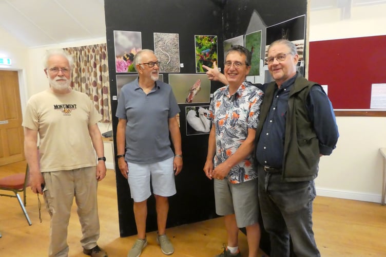 Pictured admiring the exhibition of photos at Cheriton Fitzpaine, from left, Piers Howell, Graham Redhead, Mike Porter and Tony Brown. Photo: David Nunn