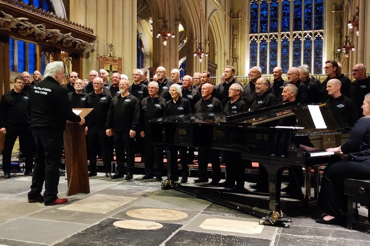 Bath Male Choir performing in Bath Abbey with their founder Conductor Grenville Jones.