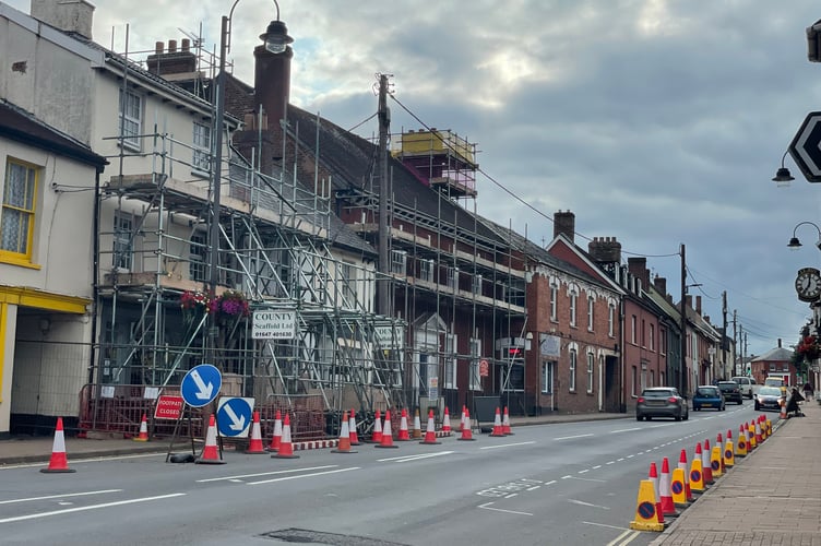 The scaffolding, barriers and cones in place but with traffic lights removed in Crediton High Street. AQ 2902